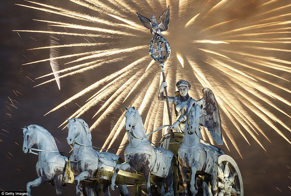 GERMANY: Fireworks explode over the Quadriga statue on top of the Brandenburg Gate in Berlin at midnight