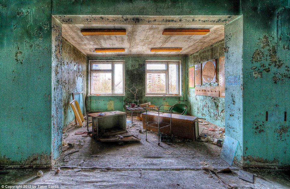 A common room in the hospital once provided an area for patients to socialise. Now it has been left to ruin with debris on the ground and exposed beams on the ceiling