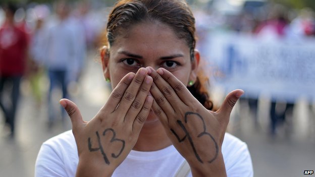 A student takes part in a protest by students of the Ayotzinapa school and parents of the 43 missing students in Acapulco on 19 November 2014. 