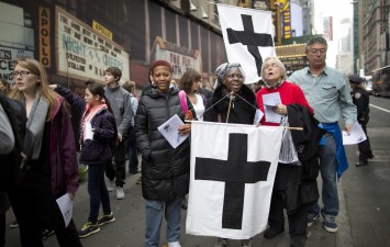 Participants in Pax Christi's Good Friday Way of the Cross procession in New York (PA)
