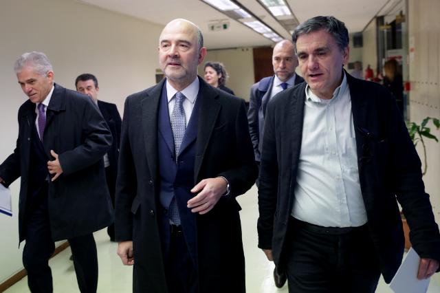 Eucleid Tsakalotos, Minister of Finance of Greece, on the right, meets with Pierre Moscovici, in the center.