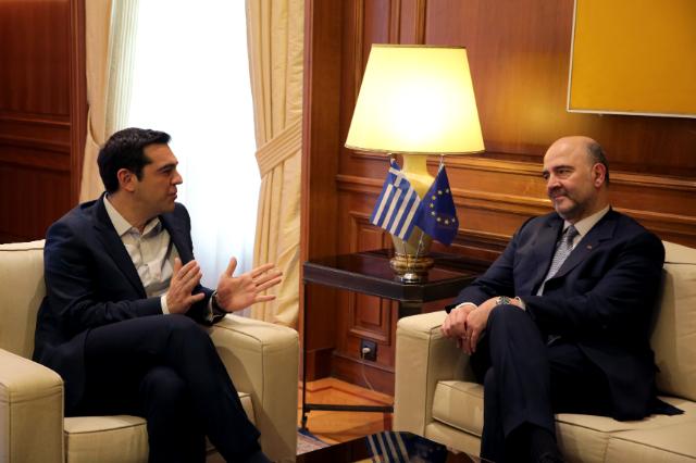 Alexis Tsipras, Prime Minister of Greece, on the left, meets with Pierre Moscovici.